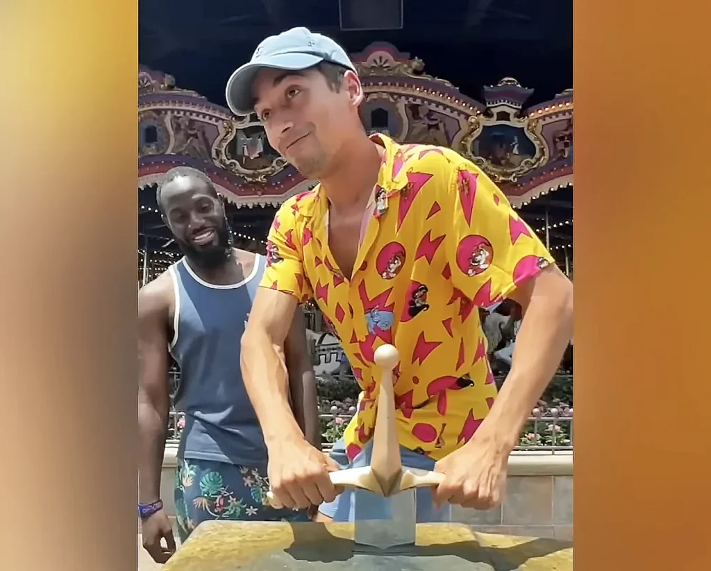 JoJo Crichton trying to pull the Sword in the Stone with Straw Hat Goofy at Magic Kingdom