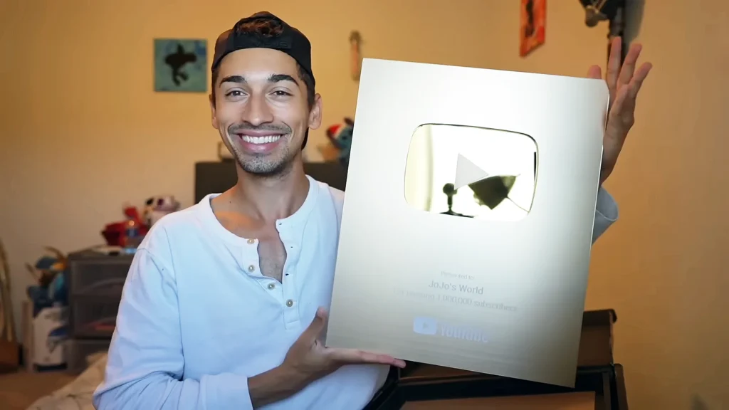 JoJo Crichton showing his one million subscribers plaque from YouTube